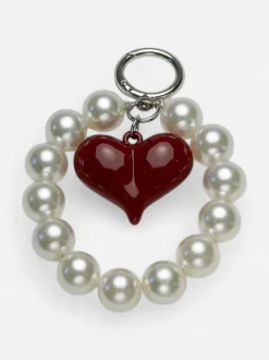Bow 19 avaimenperä, CHARM PEARL RED Valkopohjainen Kuosi